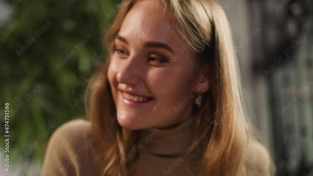 Surprised positive lady with long flowing blonde hair in warm polo neck sweater nods on blurred background in light room closeup slow motion Surprised positive lady with long flowing blonde hair in warm polo neck sweater nods on blurred background in light room closeup slow motion