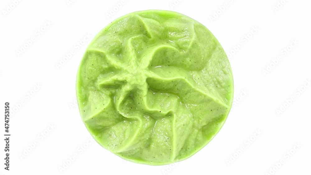 Wasabi, green sauce close-up, rotating on white background, top view. Wasabi, green sauce close-up, rotating on white background, top view.
