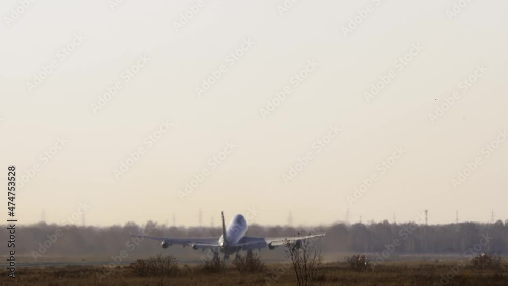 Double-decked huge plane picks up speed and takes off, climb. Airliner departure, back view. Aviation and travel concept Double-decked huge plane picks up speed and takes off, climb. Airliner departure, back view. Aviation and travel concept