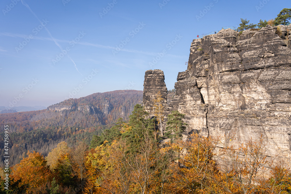 Scenic view of beautiful landscape in  Czech Saxon Switzerland national park. People hiking and looking from a high viewpoint in autumn