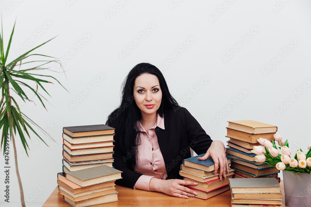 beautiful brunette woman at her desk with books for learning beautiful brunette woman at her desk with books for learning