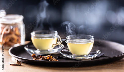 Two glasses of mulled wine and dried fruit on the bar counter. Whiskey drinks Hot Teddy in tea glasses