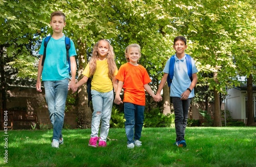 Group of schoolchildren walking together on the park © BillionPhotos.com