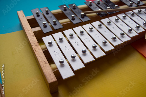 Black and white toy xylophone made of metal and wood (glockenspiel) 