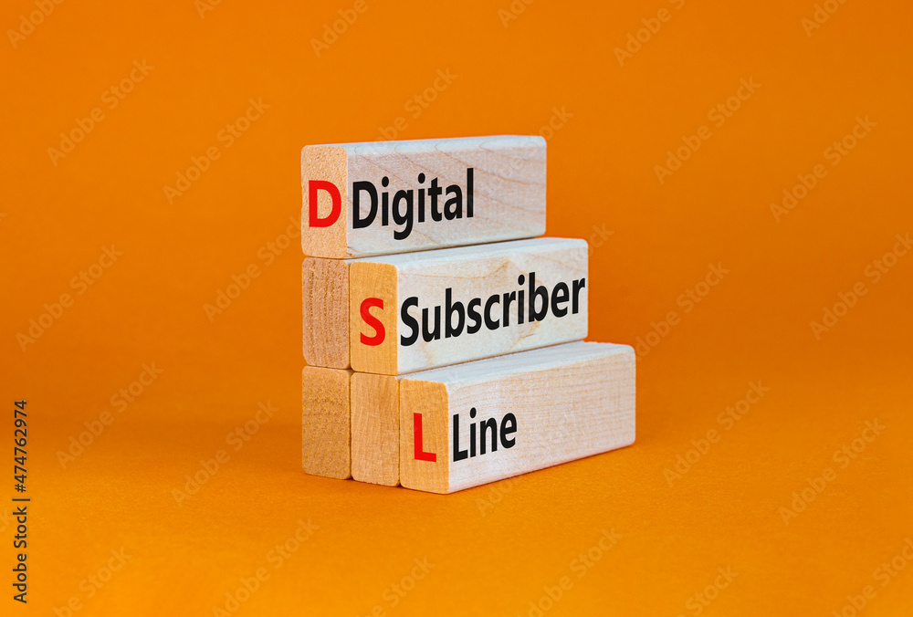 Naklejka premium DSL digital subscriber line symbol. Concept words DSL digital subscriber line on wooden blocks. Beautiful orange table, orange background, copy space. Business and DSL digital subscriber line concept.