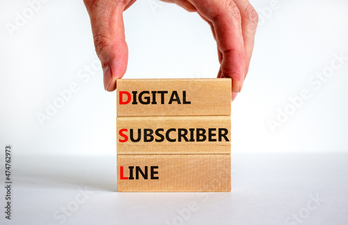 DSL digital subscriber line symbol. Concept words DSL digital subscriber line on blocks. Beautiful white background, businessman hand, copy space. Business and DSL digital subscriber line concept.