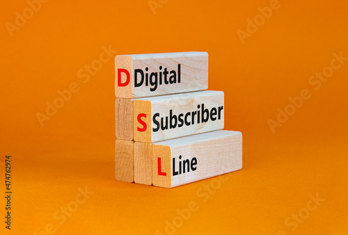 DSL digital subscriber line symbol. Concept words DSL digital subscriber line on wooden blocks. Beautiful orange table, orange background, copy space. Business and DSL digital subscriber line concept.