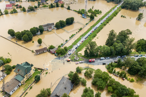 Aerial view of flooded houses and rescue vehicles saving people in Halych town, western Ukraine photo