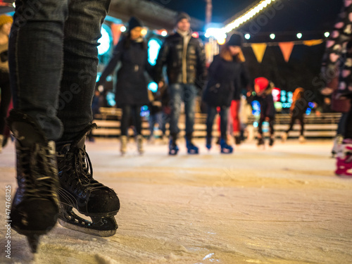 Ice skating at the city skating rink of Podil is a traditional winter experience in Kiev. Ice skating in winter for Christmas on the ice arena. photo