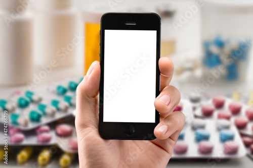 Patient hand using smartphone. Pharmaceutical use. Drugs. Pills. Prospectus. Using Smarthphone