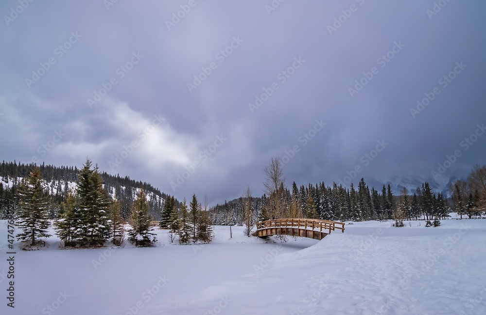 Moody Clouds Over A Snowy Cascade Ponds