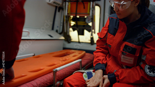 Fotografie Paramedic working in ambulance car