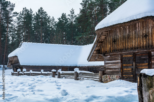 Kurzeme Peasant's horseshoe-shaped cattle yard under snow. Cattle yard’s place of origin is Rucava, Latvia, and it combined cattle shed, livestock, feeding shed, cart-house and servant barn. photo