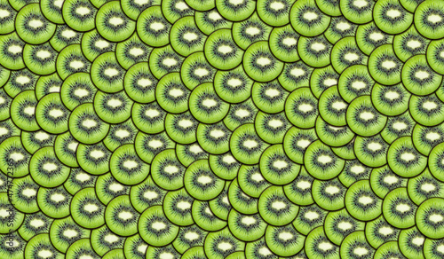 Background of fresh sliced kiwi slices. Bright juicy fruit background. Summer mood. Large texture. Food and healthy lifestyle concept.