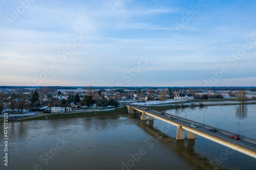 The Sully sur Loire bridge under the snow in Europe, in France, in the Center region, in the Loiret, towards Orleans, in Winter, during a sunny day.