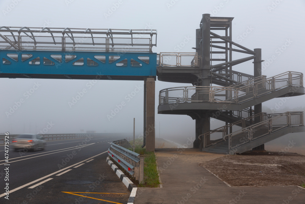 Overhead passage through the highway in the misty morning. Overhead passage through the highway in the misty morning.