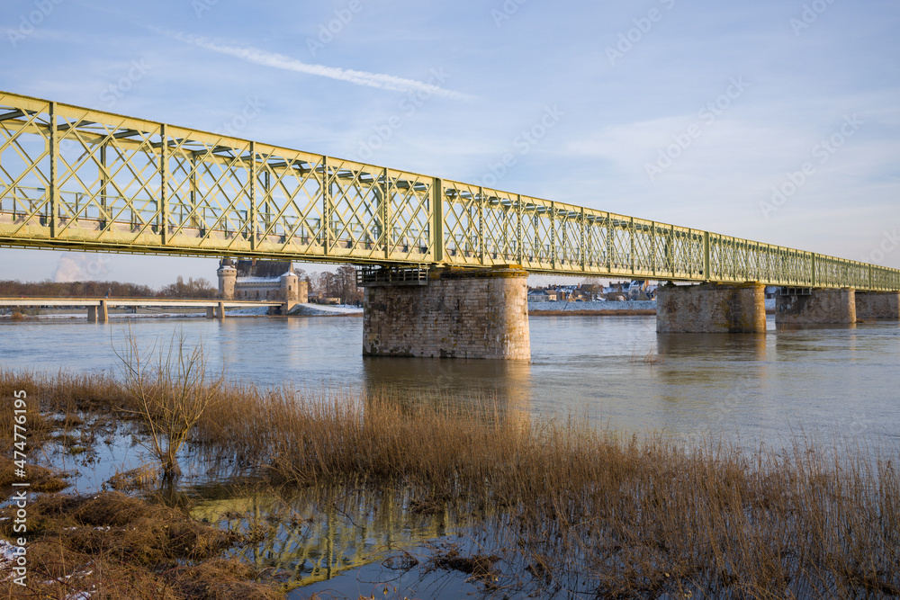 The Sully sur Loire bridge under the snow in Europe, in France, in the Center region, in the Loiret, towards Orleans, in Winter, during a sunny day.