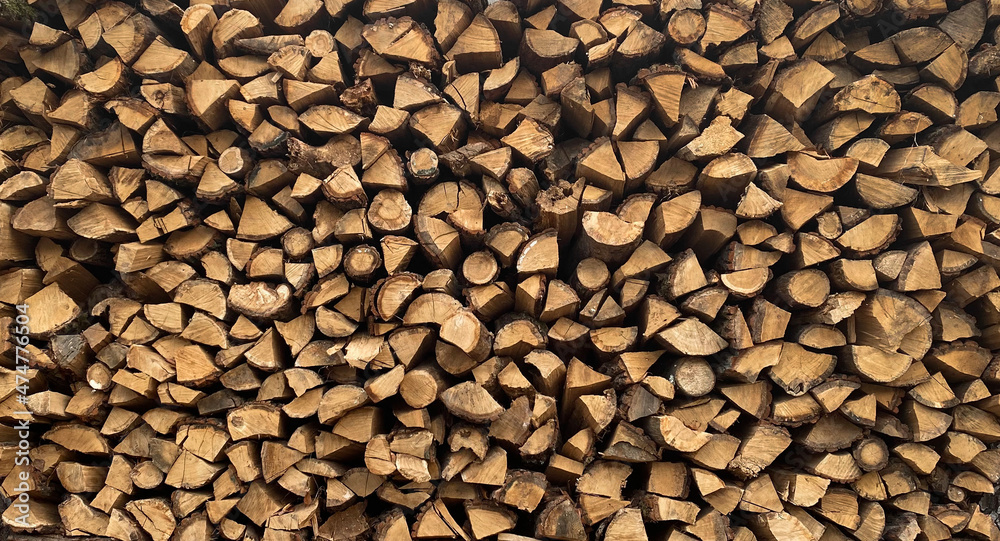 Warehouse or stack of firewood for starting a fireplace or heating a house, stock for the winter, source or template