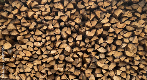 Warehouse or stack of firewood for starting a fireplace or heating a house, stock for the winter, source or template