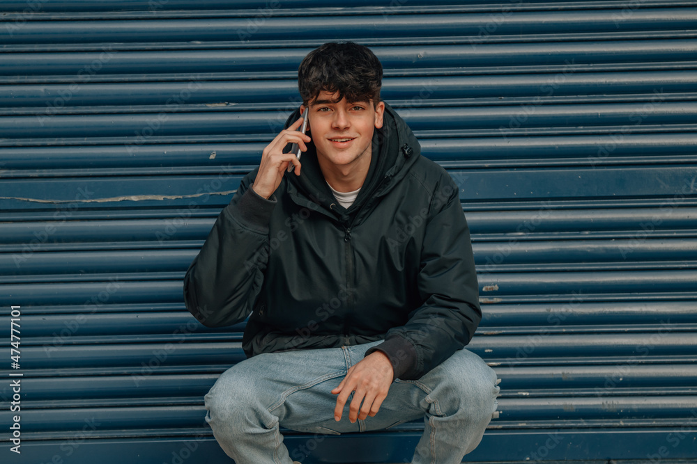 teenager with mobile phone sitting on the street teenager with mobile phone sitting on the street