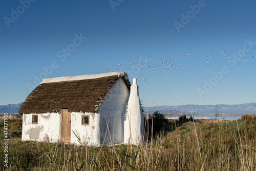 a white cottage in the rice fields.