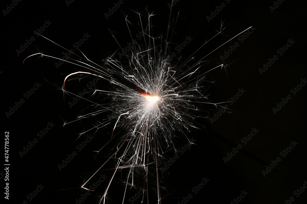 Naklejka premium Sparkler. Abstract background for Christmas and Happy New Year 2022.