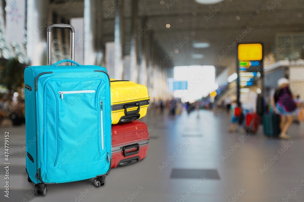 Modern stylish suitcases standing in empty airport hall, unrecognizable traveller's luggage Modern stylish suitcases standing in empty airport hall, unrecognizable traveller's luggage