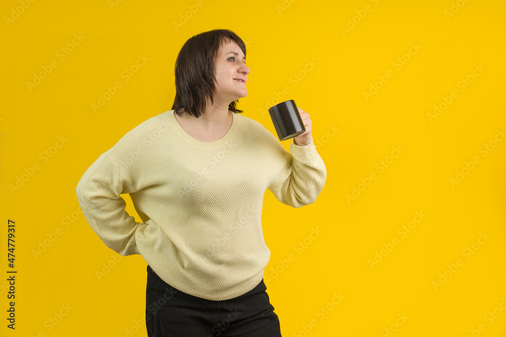 smiling brunette woman with black cup of coffee on yellow background smiling brunette woman with black cup of coffee on yellow background