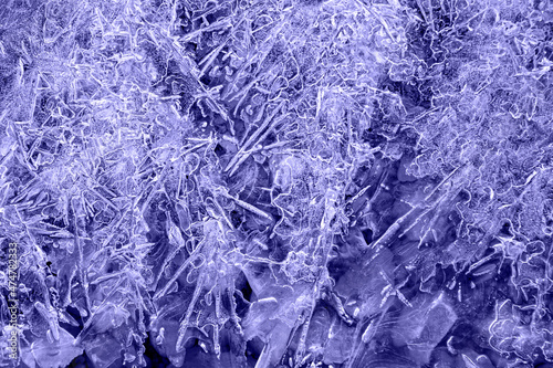 blue tint with purple undertone ice patterns on winter glass, ice crystals. abstract background frost close-up Very Peri