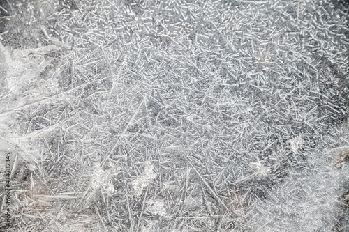 ice patterns on winter glass, ice crystals. abstract  frost background closeup