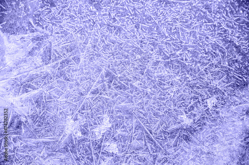 blue tint with purple undertone ice patterns on winter glass, ice crystals. abstract background frost close-up Very Peri