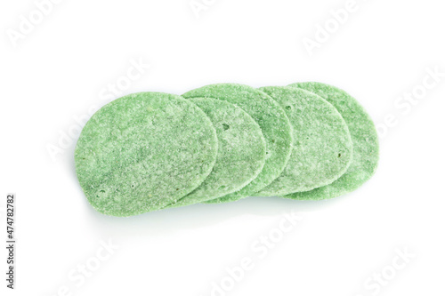 Green potato chips isolated on white background. Top view, close up.