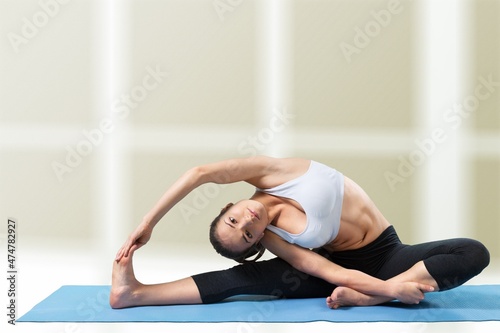 young flexible girl does yoga and gymnastics, yoga and fitness concept