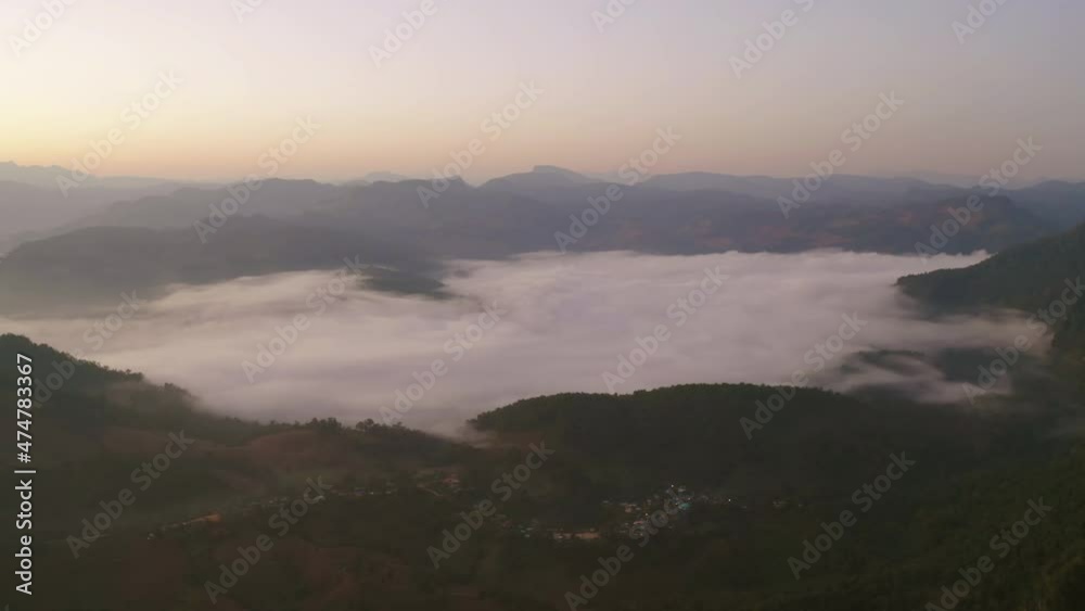 Aerial top view of forest trees and green mountain hills with sea fog, mist and clouds. Nature landscape background, Thailand. Aerial top view of forest trees and green mountain hills with sea fog, mist and clouds. Nature landscape background, Thailand.
