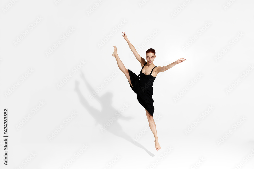 Female caucasian ballet dancer isolated in studio