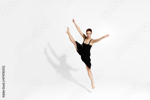 Female caucasian ballet dancer isolated in studio