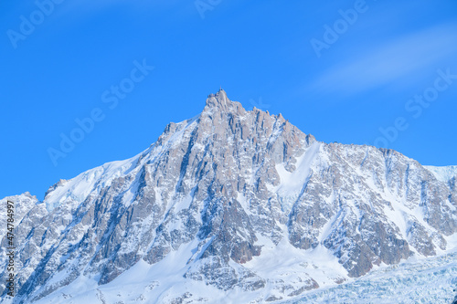 The Aiguille du Midi in the Mont Blanc massif in Europe, France, the Alps, towards Chamonix, in spring, on a sunny day. © Florent