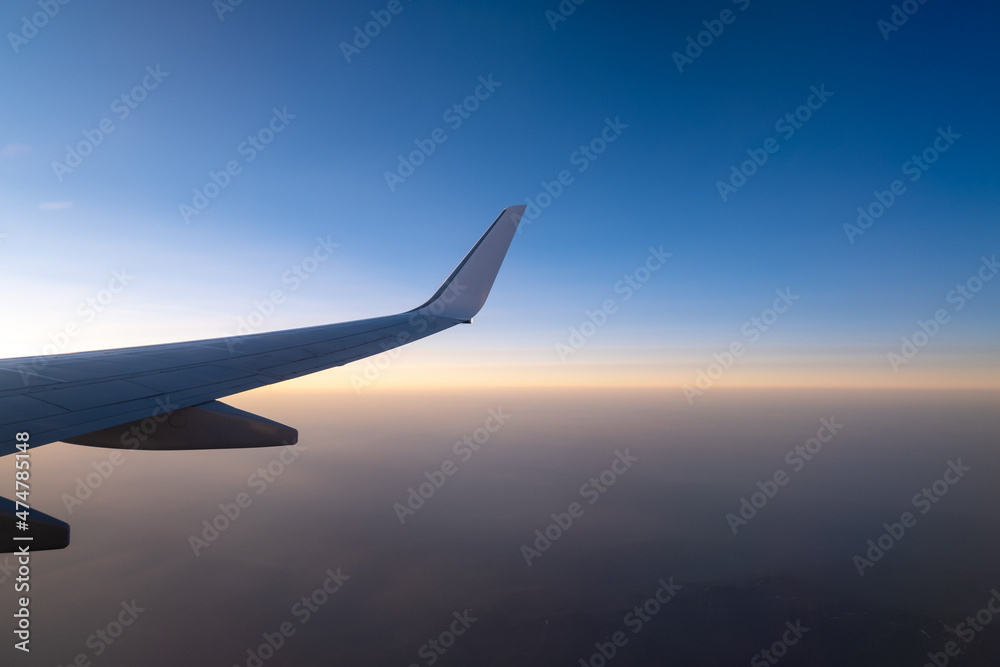 flying and traveling, view from airplane window on the wing on sunset time flying and traveling, view from airplane window on the wing on sunset time