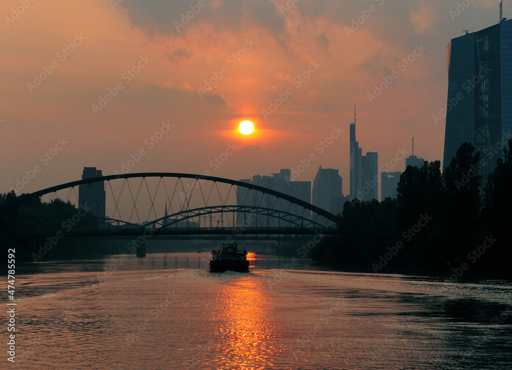 Obraz premium View From The Main River At The European Central Bank Tower To The Skyline Of The Banker's City Frankfurt Am Main In Hesse Germany On A Beautiful Summer Day Before Sunset