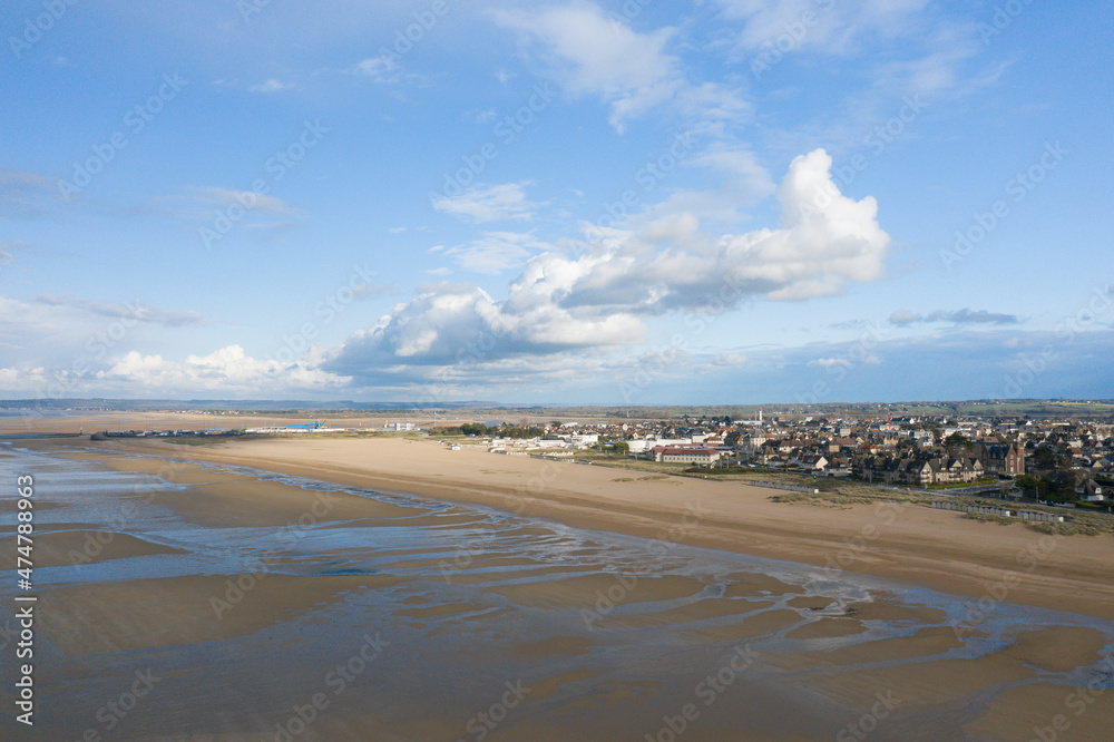 The beautiful city center of Ouistreham by the sandy beach in Europe, France, Normandy, in summer, on a sunny day.