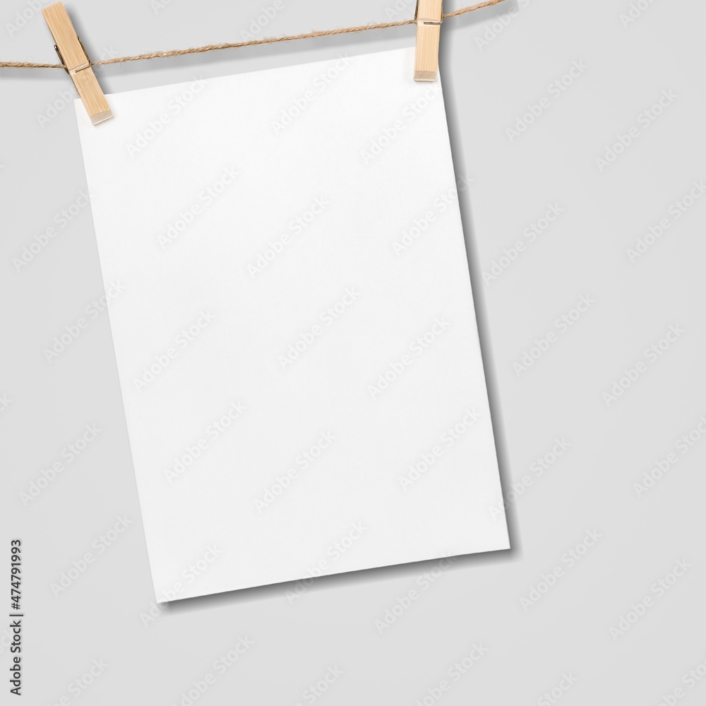 Paper hanging on rope with wooden clothespins on background Paper hanging on rope with wooden clothespins on background