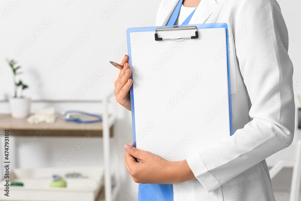 Female doctor with clipboard in medical office Female doctor with clipboard in medical office