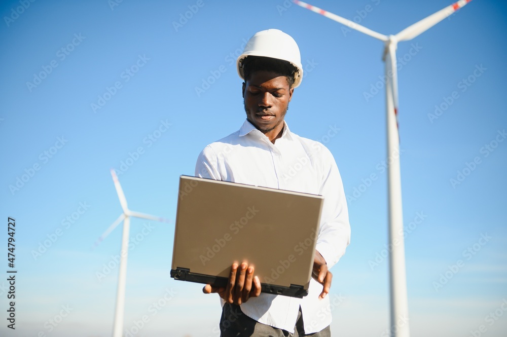 Engineer African man standing with wind turbine