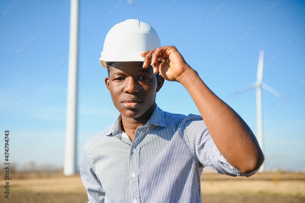 Engineer African man standing with wind turbine