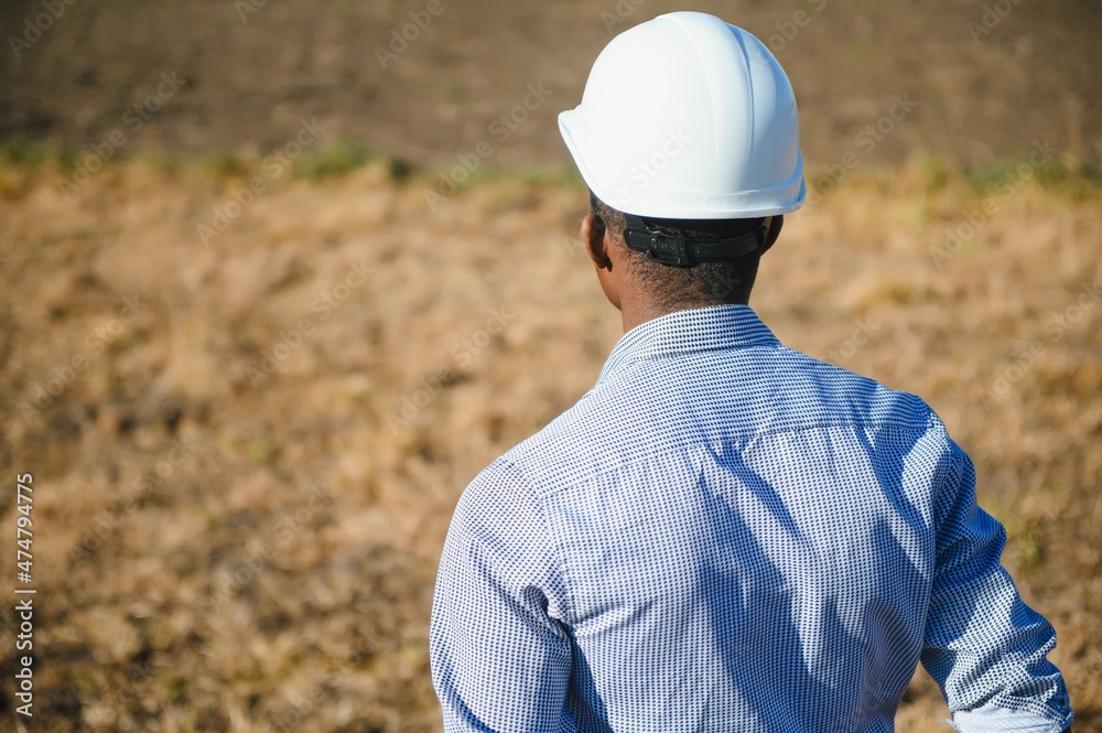 African American worker in a construction helmet African American worker in a construction helmet