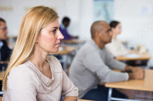 Portrait of woman in group of students in a university audience