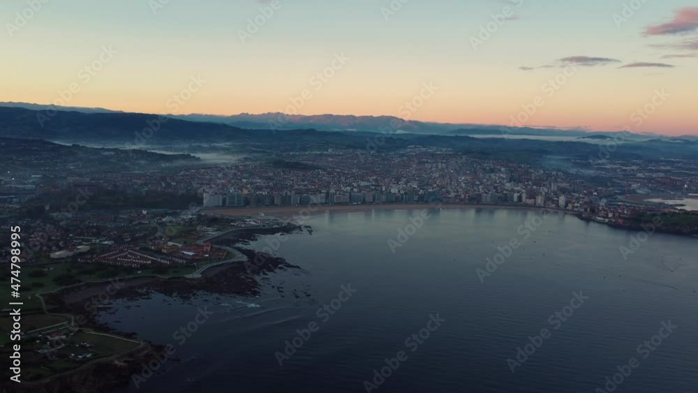 Gijon drone fly above the city in north of Spain, sunset aerial view of sand beach tourist holiday destination Gijon drone fly above the city in north of Spain, sunset aerial view of sand beach tourist holiday destination
