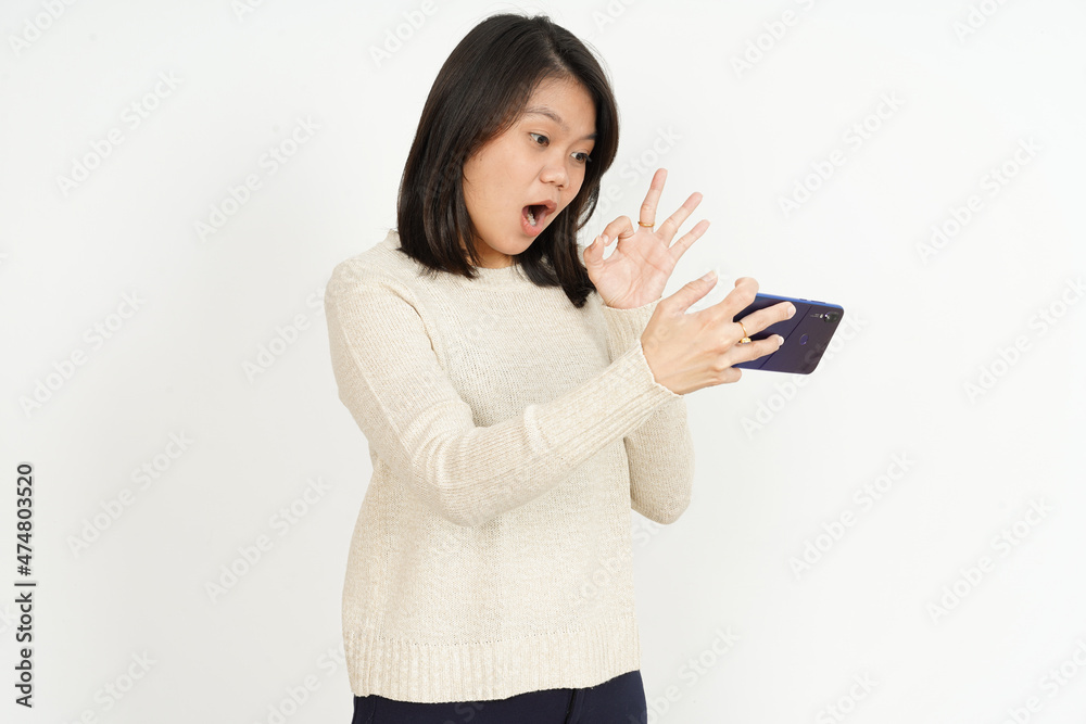 Playing Mobile Game on smartphone of Beautiful Asian Woman Isolated On White Background Playing Mobile Game on smartphone of Beautiful Asian Woman Isolated On White Background