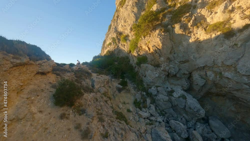 Drone Through Rock Arch And Over Coastal Cliffs