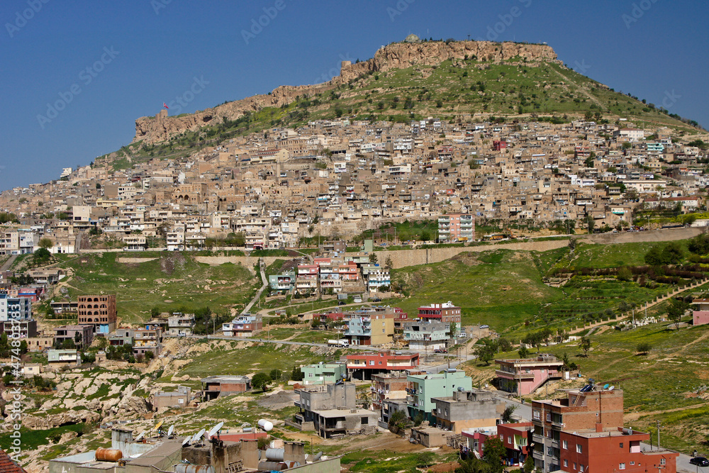 Ruins of fortress on hill and residential area of Mardin on slope, Eastern Anatolia, Turkey